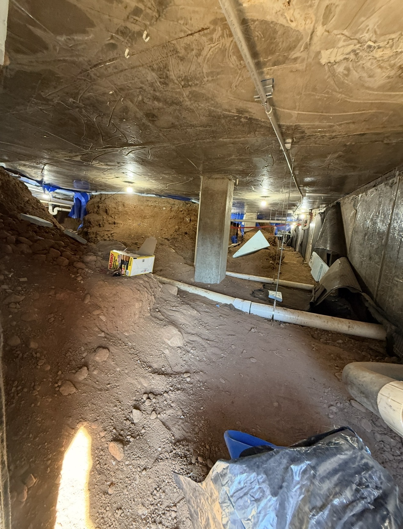 Crawl space after removal of asbestos-containing pipe insulation and debris