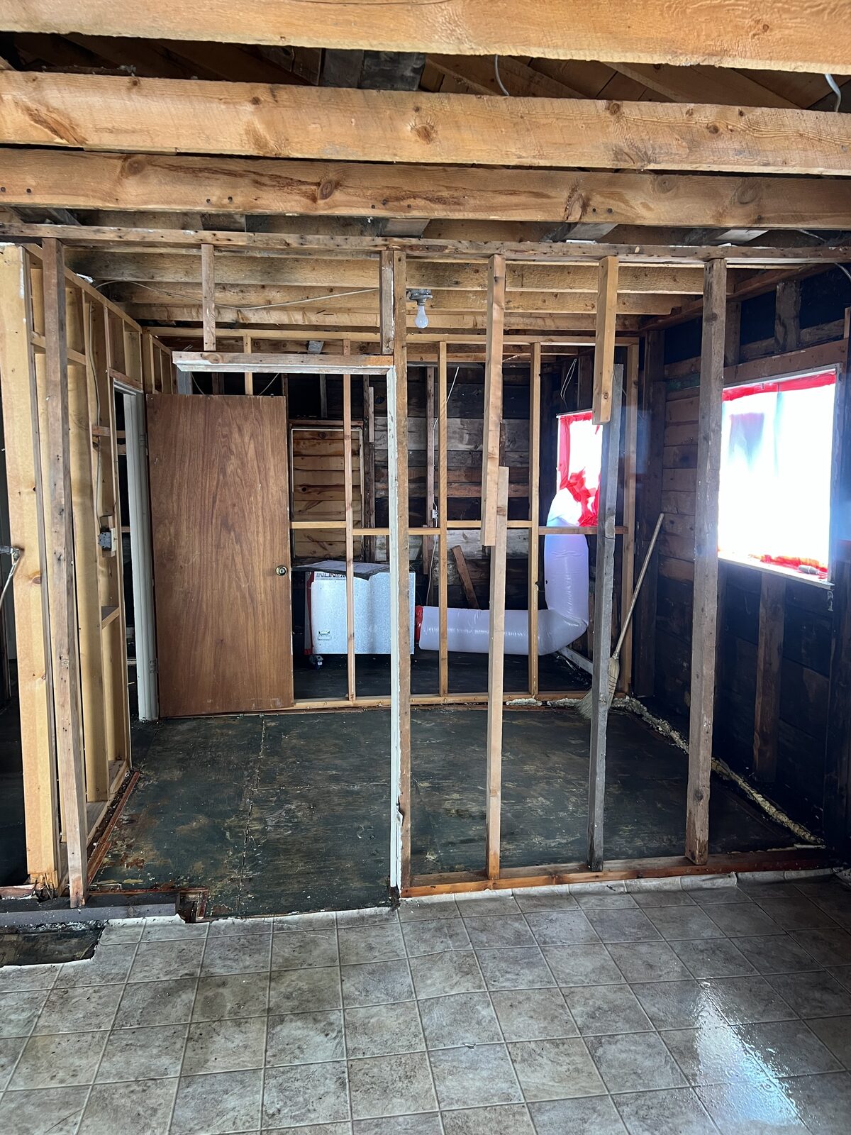 Closet stripped to original wood lath after removal of asbestos-containing wall materials
